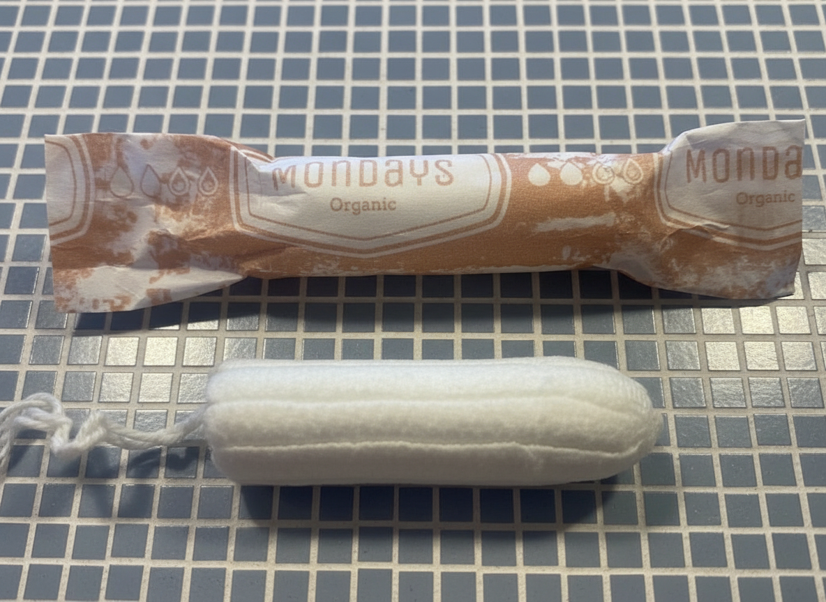 Mondays digital (non-applicator) regular organic plastic-free tampons  (absorbency regular) on a blue tiled bathroom shelf