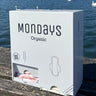 A white free-vend Mondays dispenser for  the provision of organic pads & digital (non applicator) tampons in workplaces, schools and sportsvenues