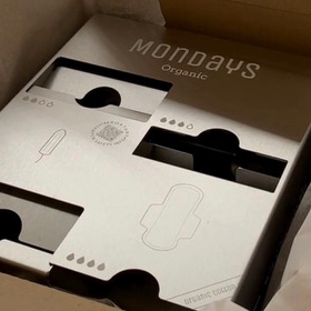 Stainless Steel Mondays QUAD-D Menstrual Product Dispenser for 2 types of non-applicator tampon and 2 types of sanitary pad sitting it's 100% plastic-free packaging